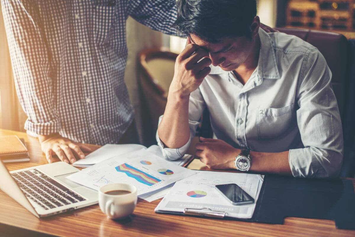 Business executive facing operational budget challenges, reviewing financial constraints that impact strategic decision-making and daily operations.